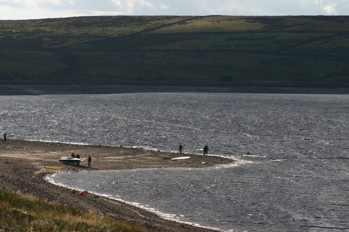 Windsurfers And Sailors On Shore Of Grimwith Reservoir